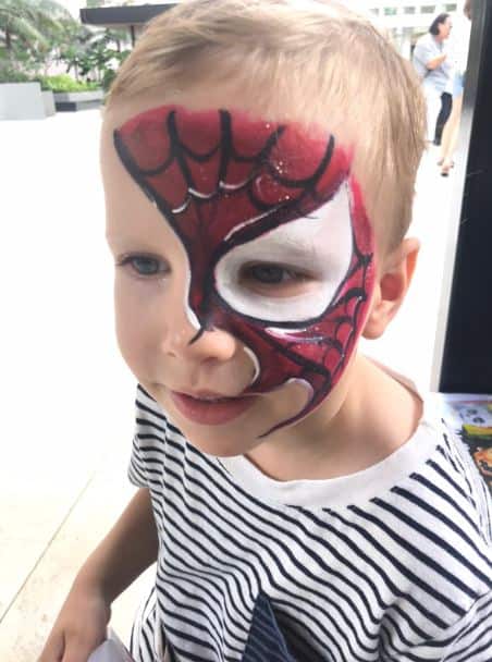 half face spiderman face painting on child